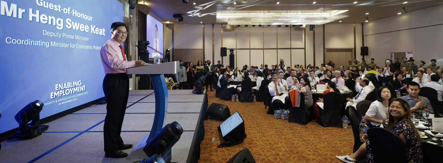 Mr. Heng Swee Keat at podium, addressing a seated audience at Enabling Employment dinner.